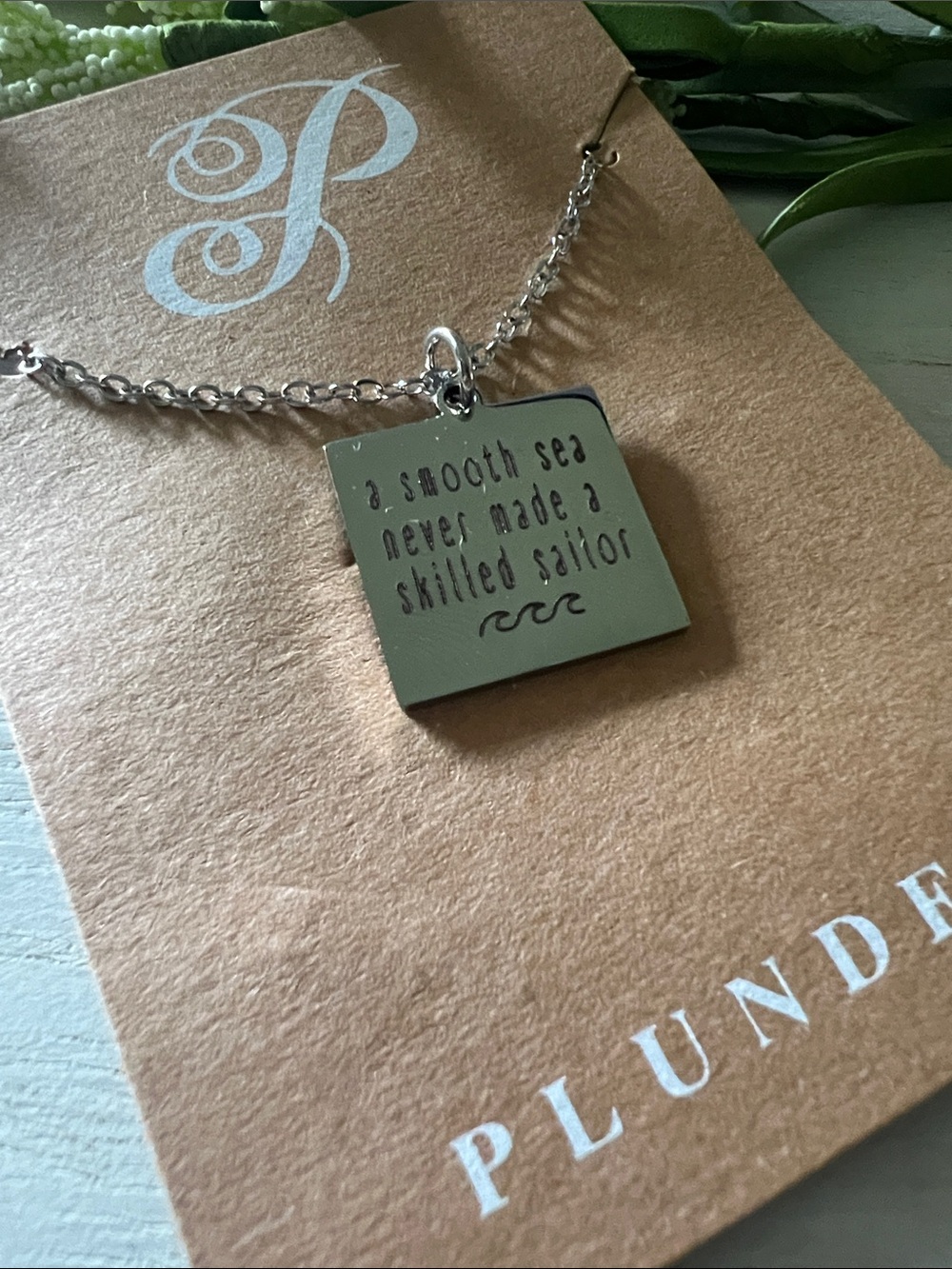 Plunder silver tone necklace “a smooth sea never made a skilled sailor”